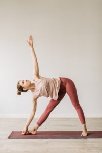 woman doing triangle yoga pose